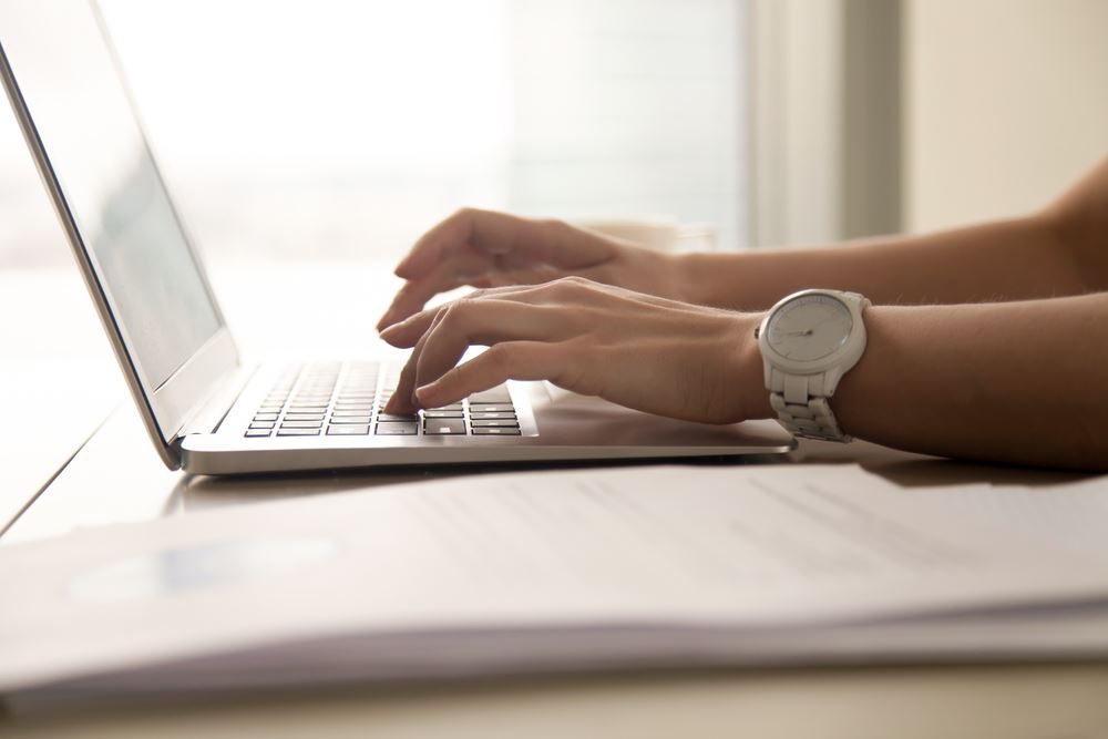 woman typing on computer