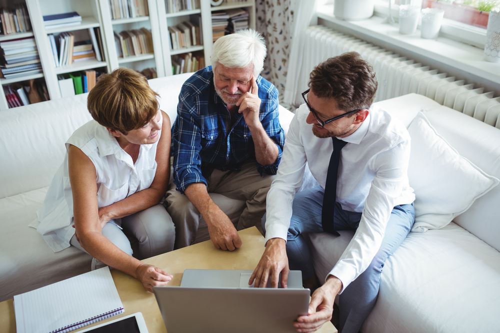 financial advisor with older couple in living room