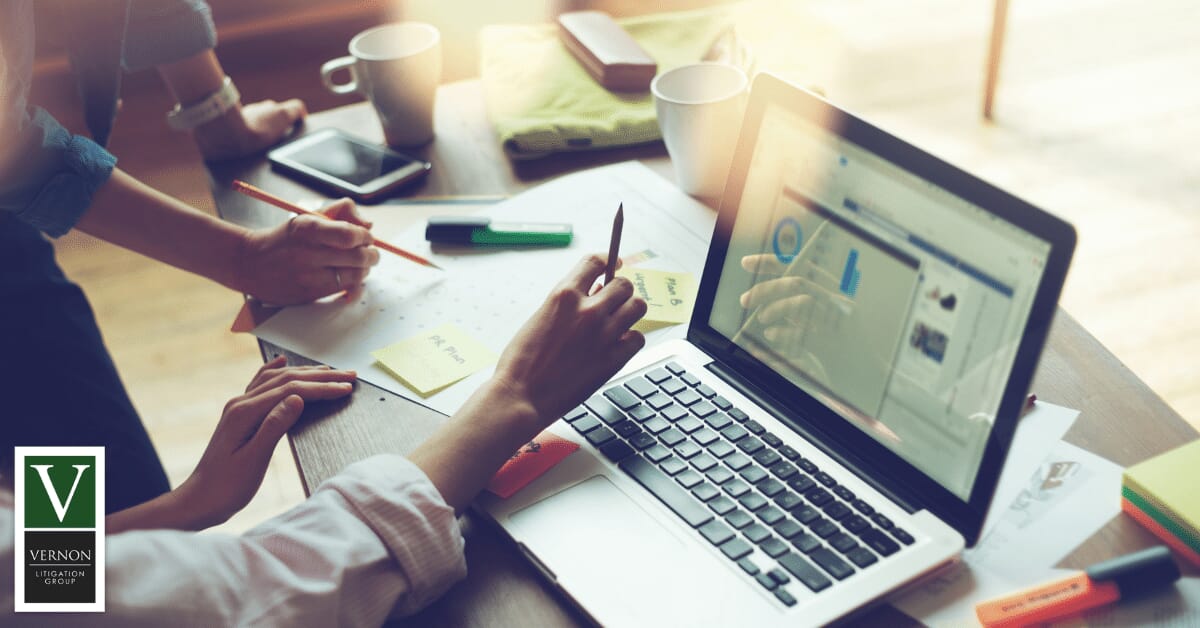 individuals on computer looking at information